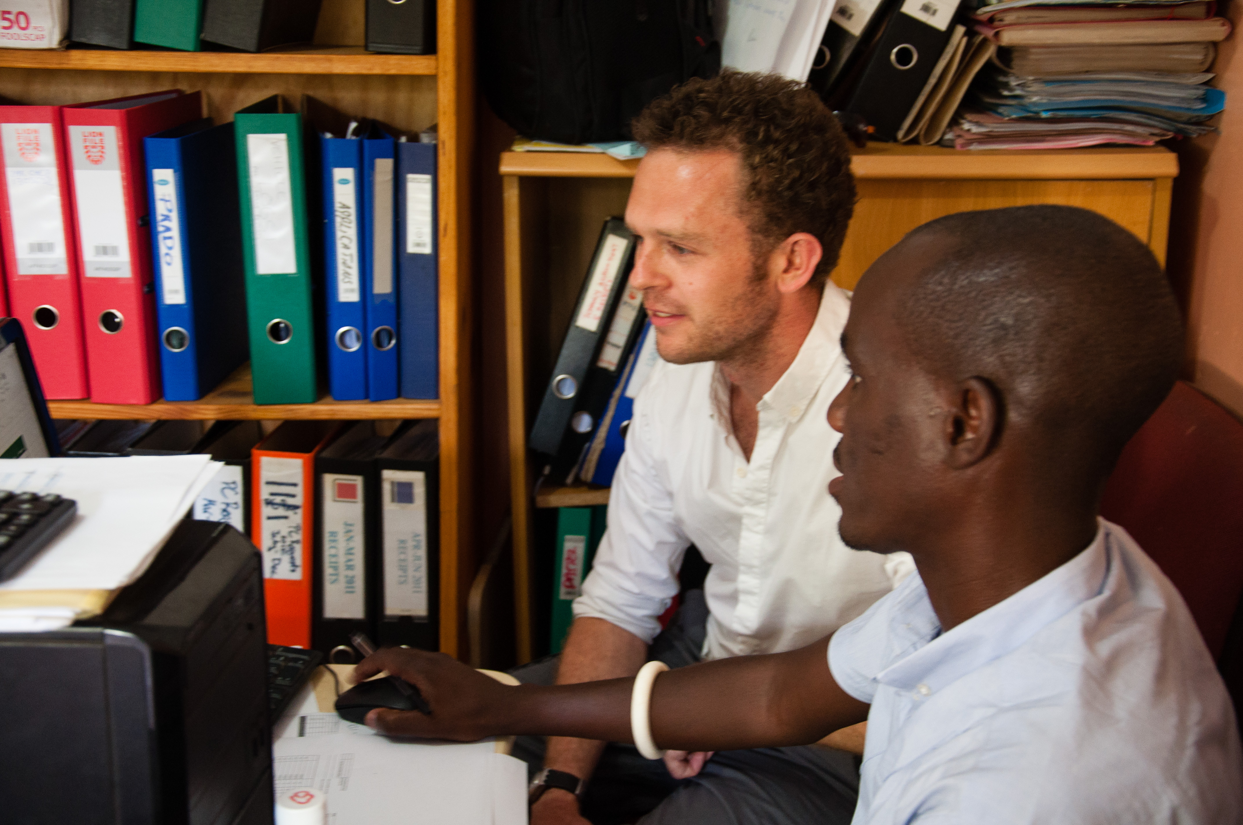 Afid volunteer shawn coaches charity partner accountant at desk
